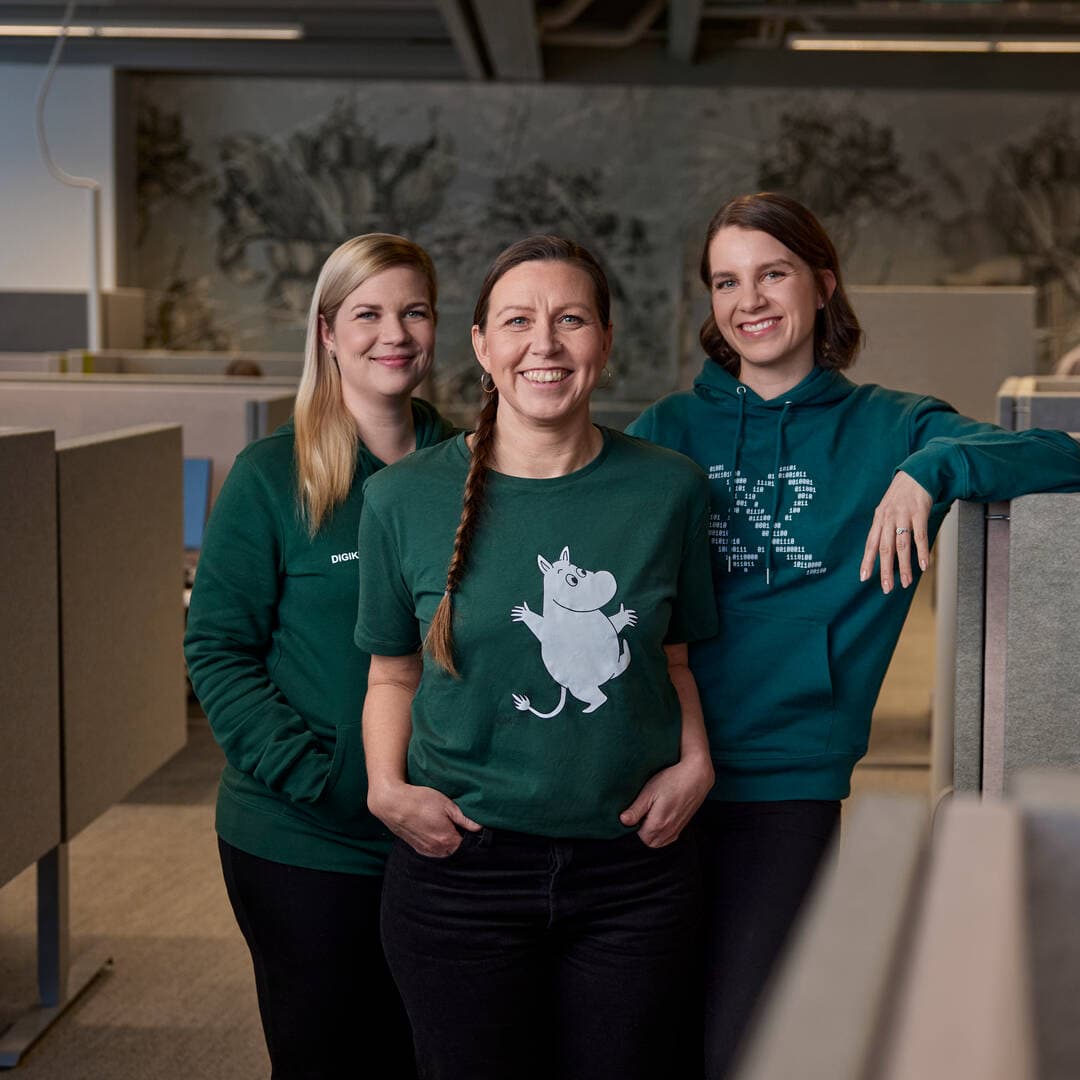 Three Mehiläinen digital nurses stand side by side and smile looking at the camera